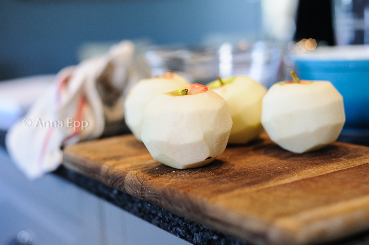 peeled apples sitting on a cutting board